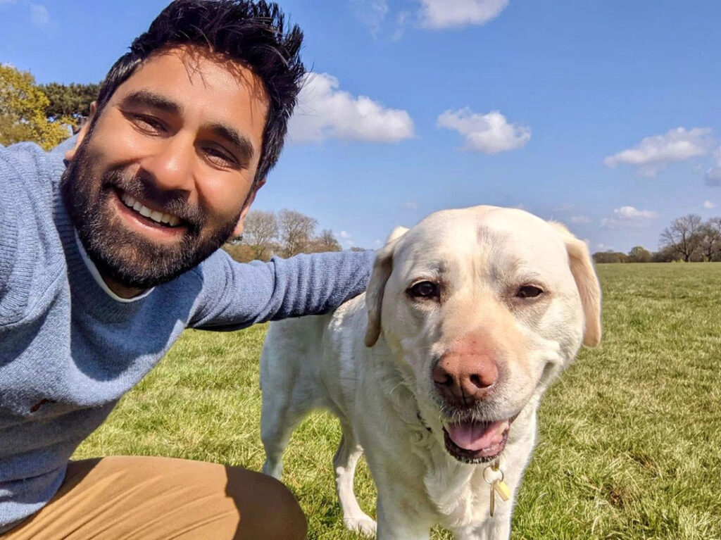 Amit and Kika smile in the sunshine in a happy summer shot, side by side.