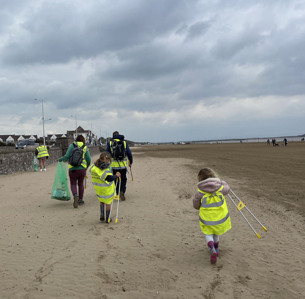 Volunteers take to Weston's beach, wearing high vis jackets.