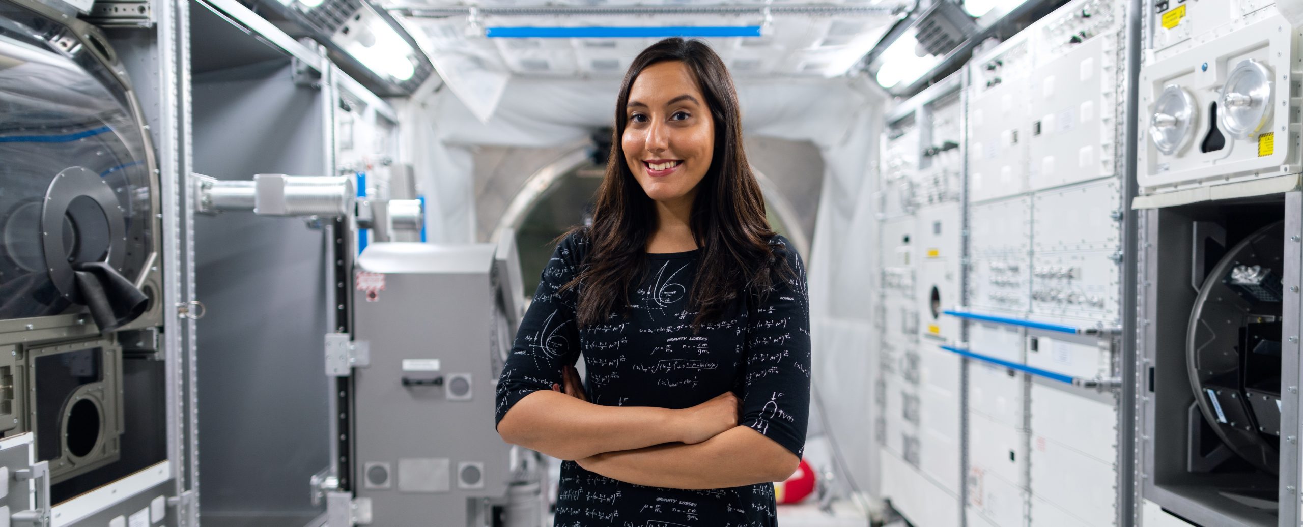Space Engineer Vinita Marwaha Madill stands inside a rocket